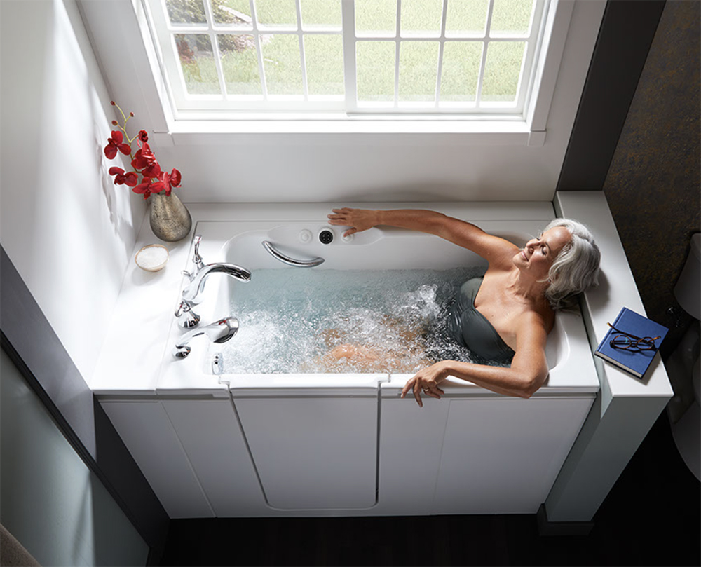 Woman relaxing with hydrotherapy in KOHLER Walk-In Bath