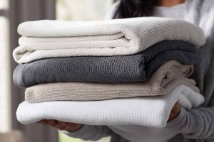 Woman holding Kohler's Turkish bath linens.