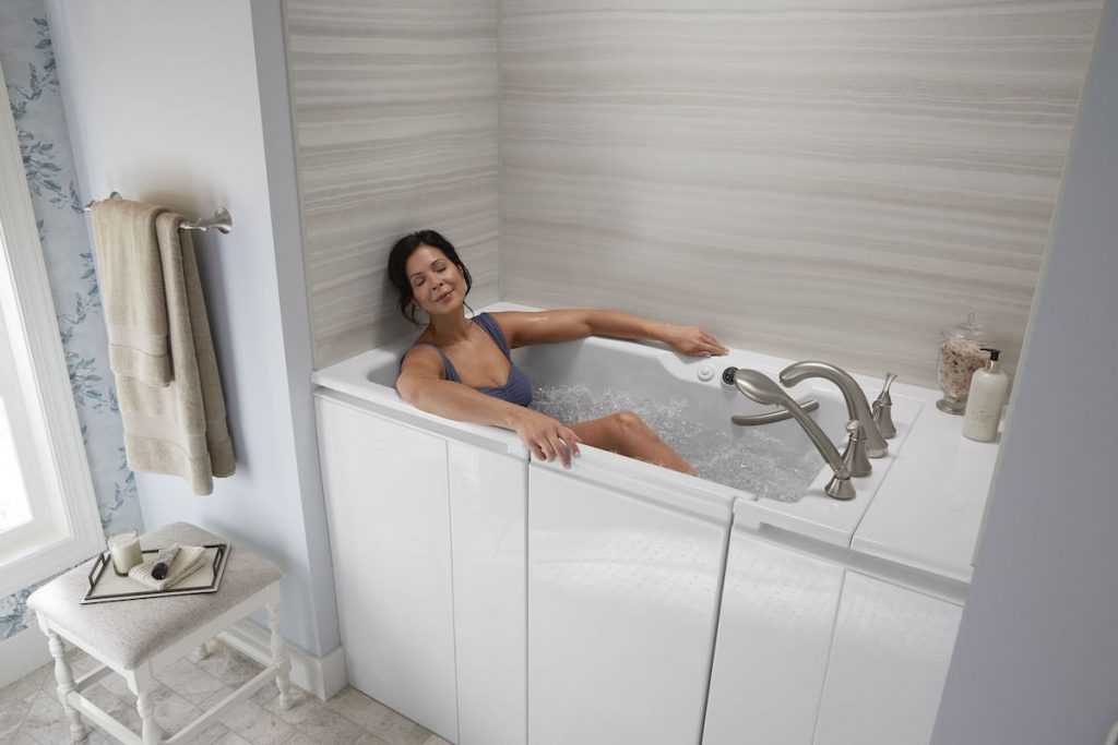 Woman soaks in KOHLER Walk-In Bath