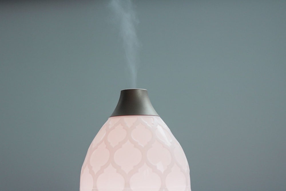Essential oil diffuser releases aroma into air.