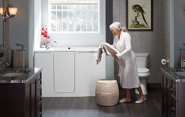 woman putting laundry into hamper