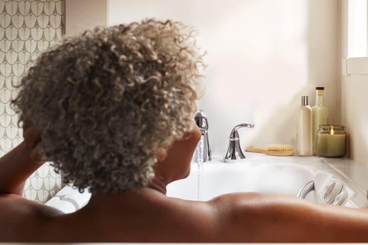 Women relaxing in bath looking into bath