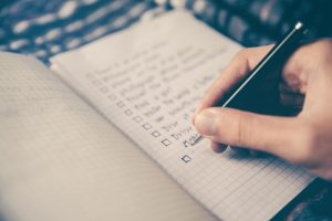 Close up of person writing a list