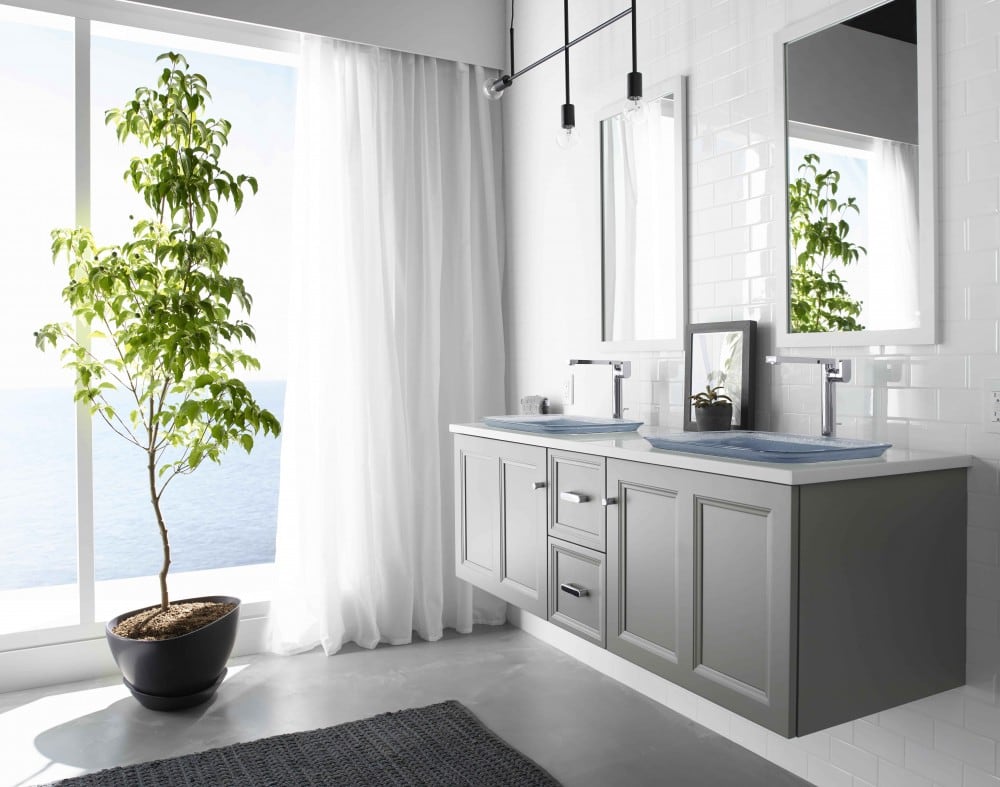 Floating grey vanity and potted tree in bathroom