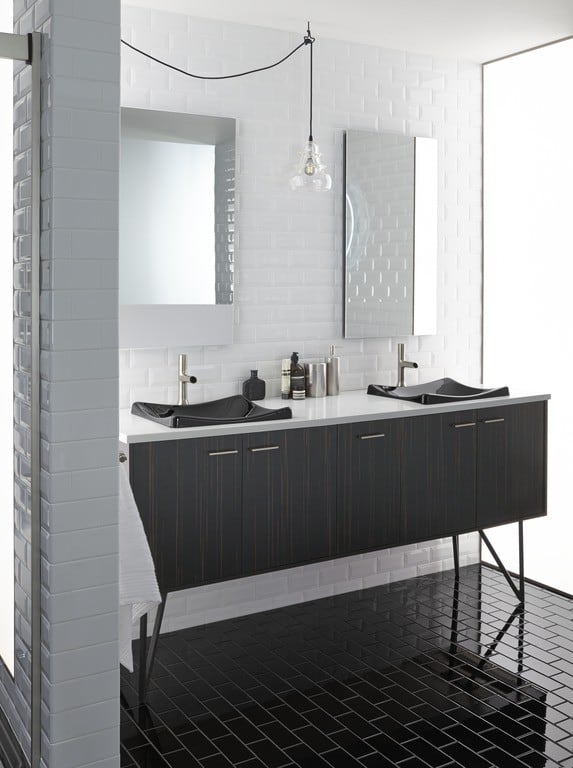 Bathroom with white subway tiled walls and a black subway tiled floor