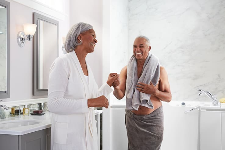 Man and woman smiling in bathroom