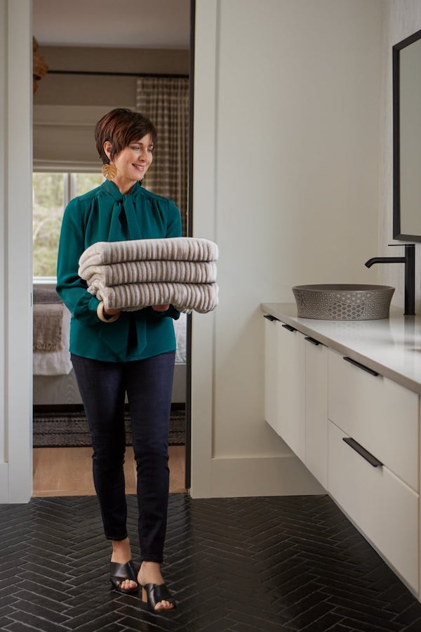 Person placing towels in drawer