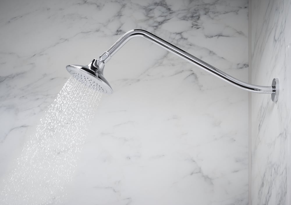 gooseneck shower arm in Polished Chrome spraying water