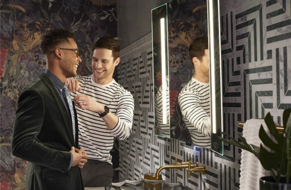 two men in front of lighted mirror