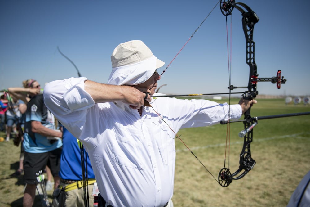 Man draws archery bow