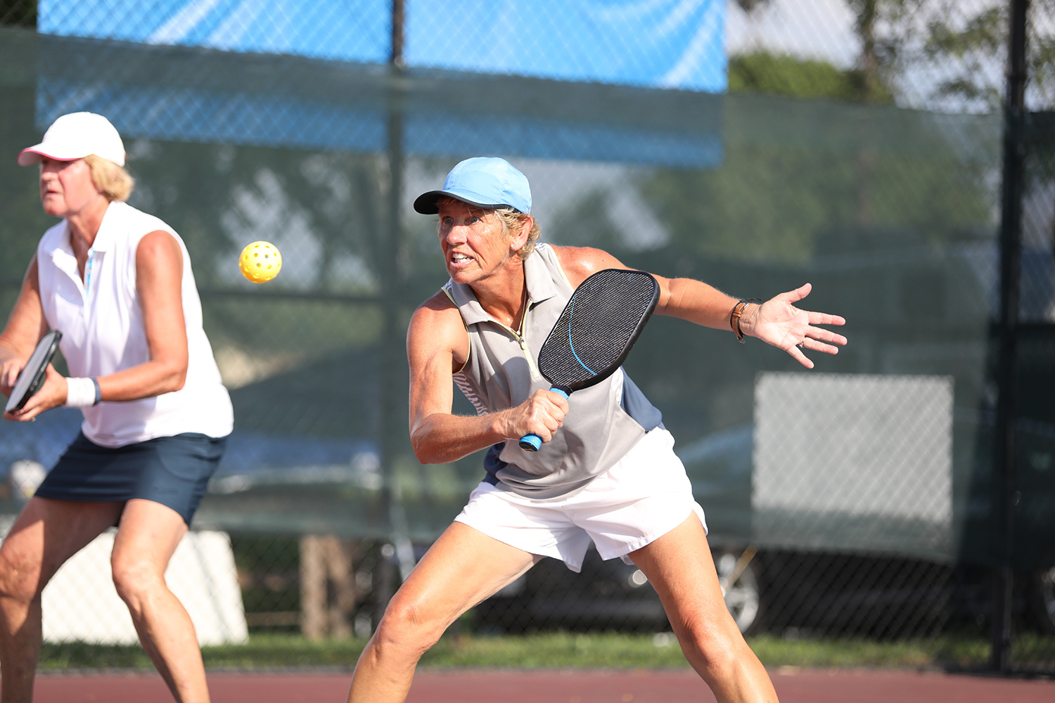 Women playing doubles pickleball