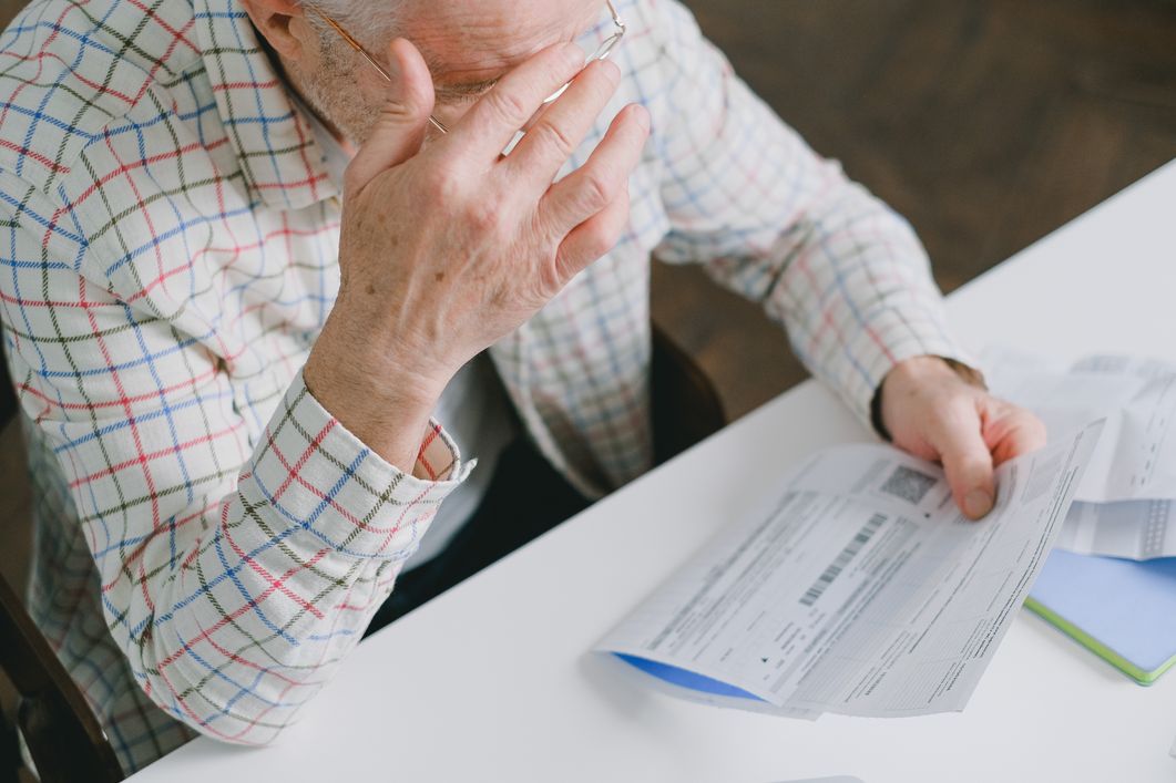 old man reviewing bills