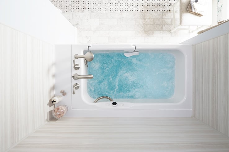 Walk-In Bath with hydrotherapy jets running and bath salts on ledge