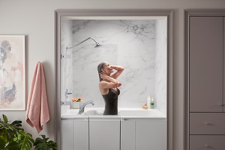 Woman standing in walk-in bath as she takes a shower