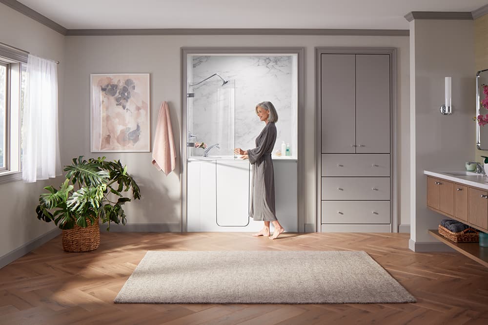 Woman in bathrobe entering a walk-in bathtub