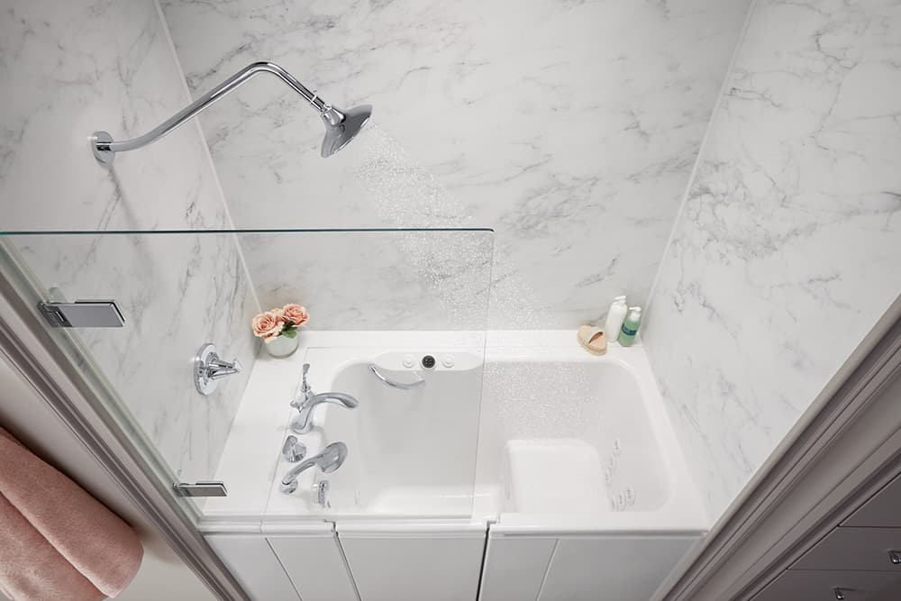 KOHLER Walk-In Bath with the Shower Package, featuring a gooseneck shower arm and a Bath Screen