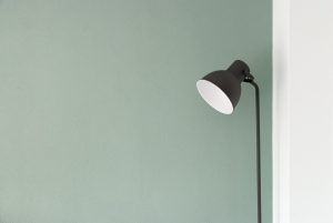 floor lamp with a green wall in the background.