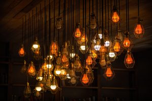 collection of warm-hued light bulbs hanging from the ceiling
