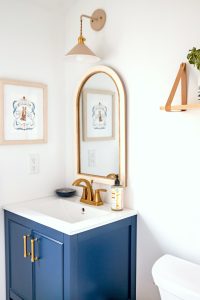 blue bathroom sink with mirror and picture