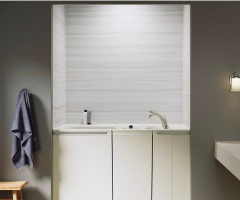 view of walk-in bath with vein cut dune wall surround