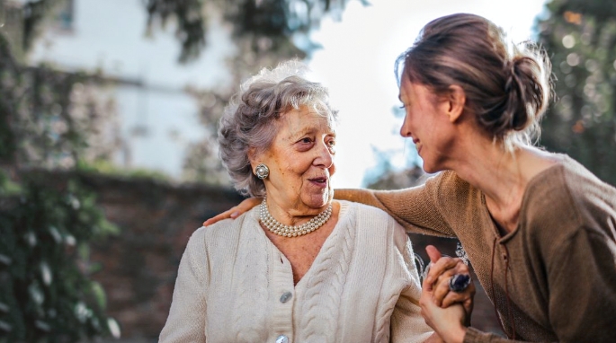 woman with arm around elderly woman